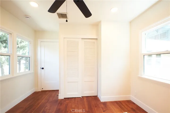 Bedroom 3 hardwood floor, recessed lighting, backyard view