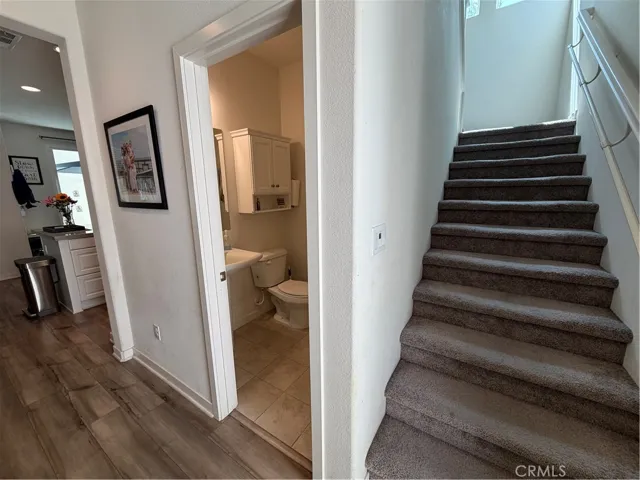 Entryway to bathroom and stairs