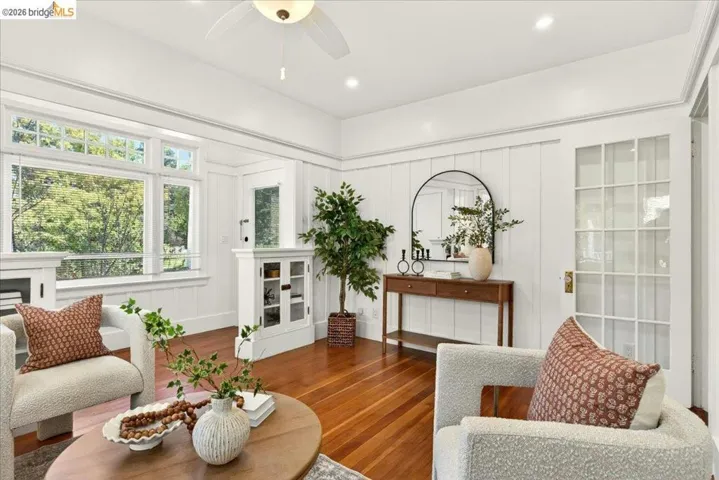 Hardwood flooring throughout featuring white board and batten wall details