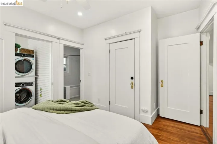 Bedroom featuring wood-finish flooring and white paneled doors