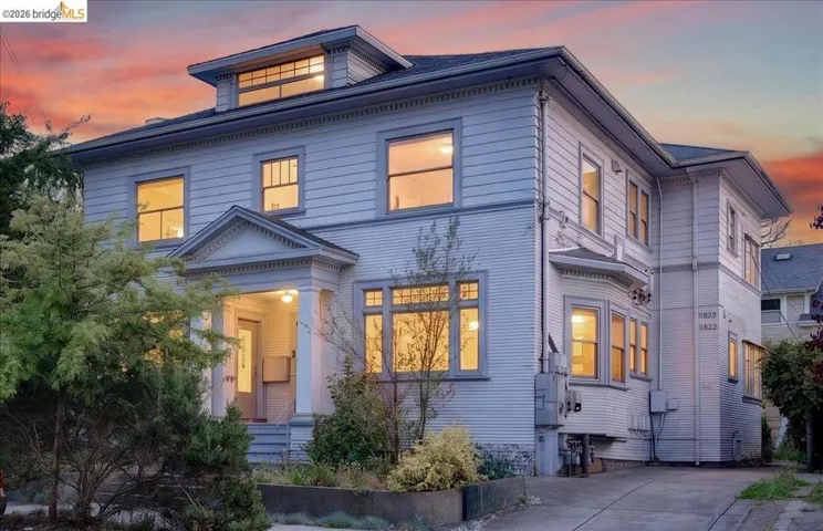 Traditional-style residence featuring horizontal siding and a prominent front entry porch with classical columns