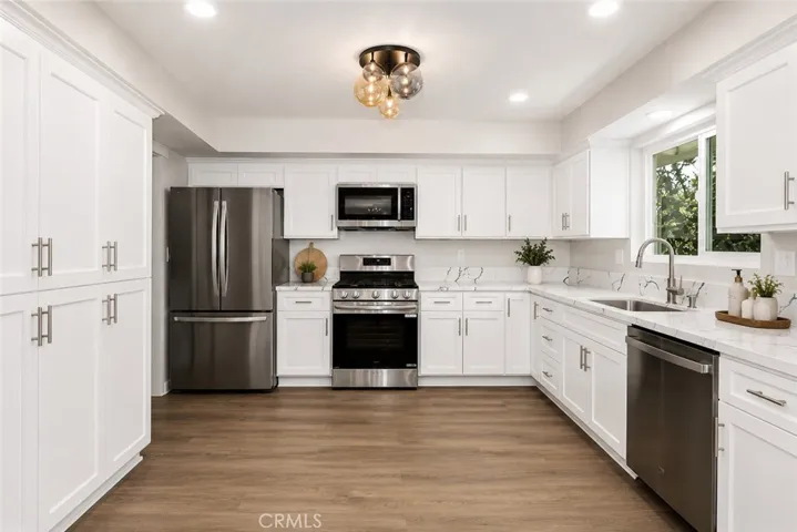 Remodeled kitchen with abundant cabinetry, quartz countertops, and stainless-steel appliances.