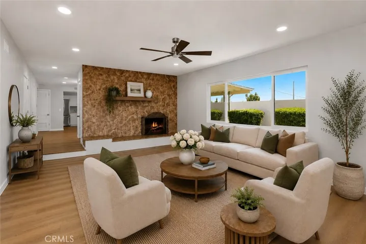 Spacious living room featuring a stunning floor-to-ceiling stone fireplace.