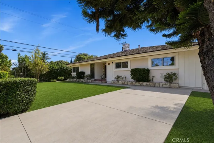 Front yard lawn has been virtually enhanced to show aesthetic potential