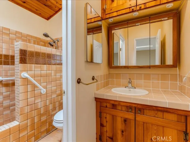Three quarter bathroom of off kitchen area.