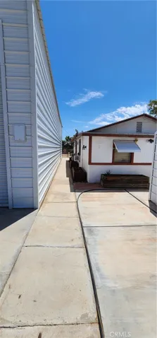 Walkway between RV garage and primary house, toward front yard and river