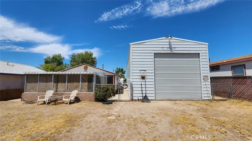 Front view of primary house and RV garage, facing west toward the street