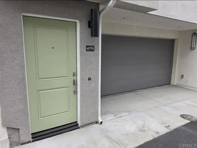 New construction exterior with attached garages in a detached PUD community.