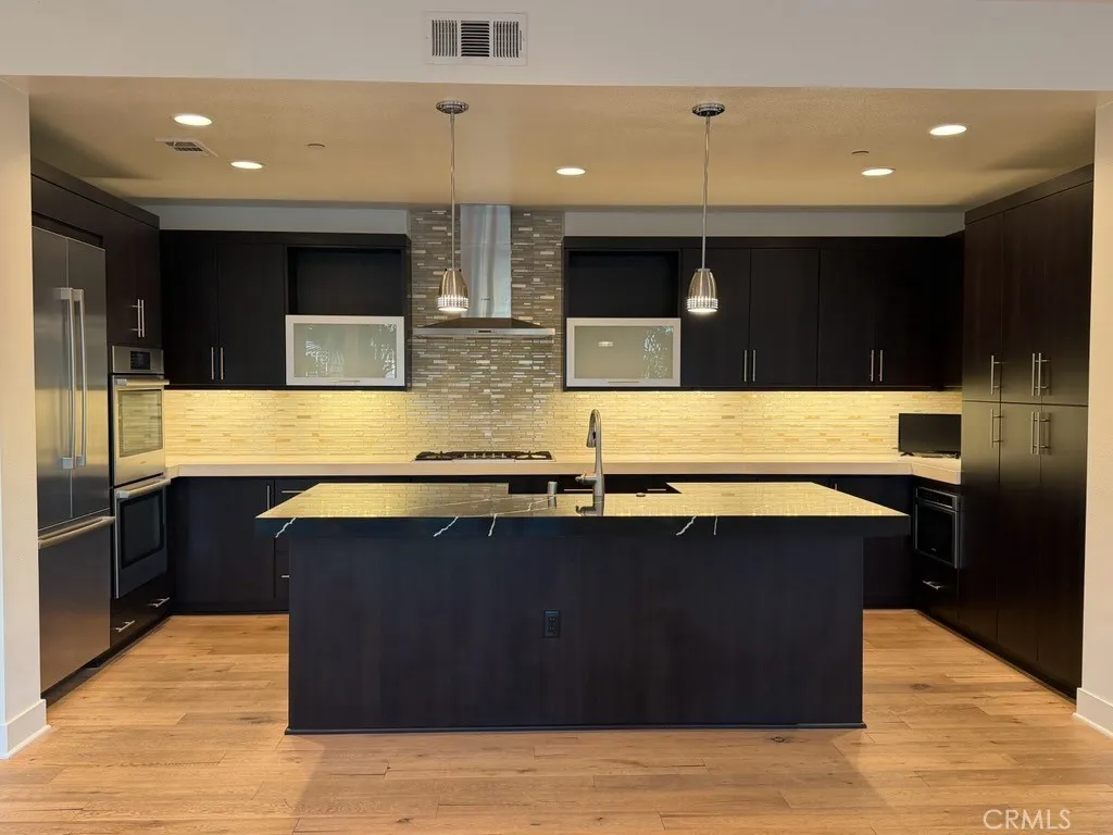 Kitchen with designer countertop and full backsplash Kitchen with designer countertop and full backsplash