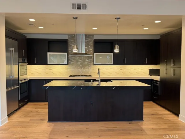 Kitchen with designer countertop and full backsplash