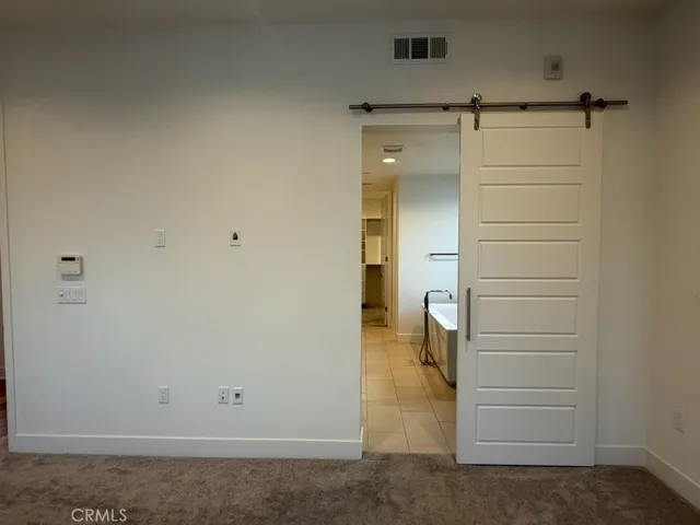 Barn door to master bathroom
