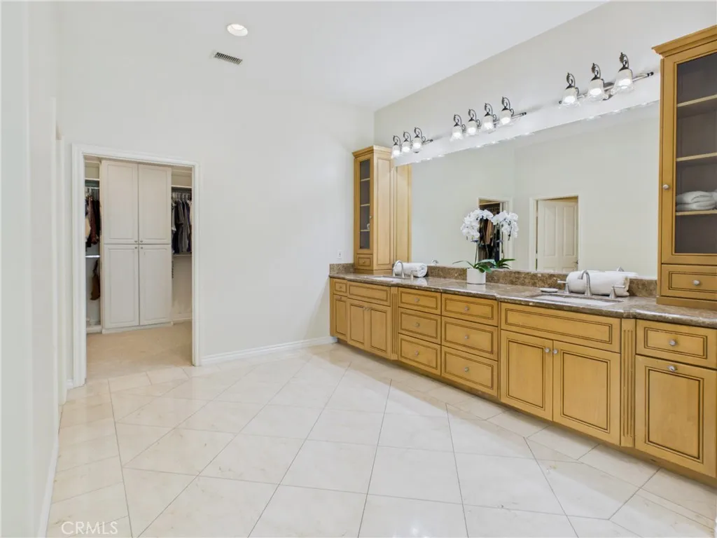 Extended vanity with built-ins for linens, toiletries, or decor.