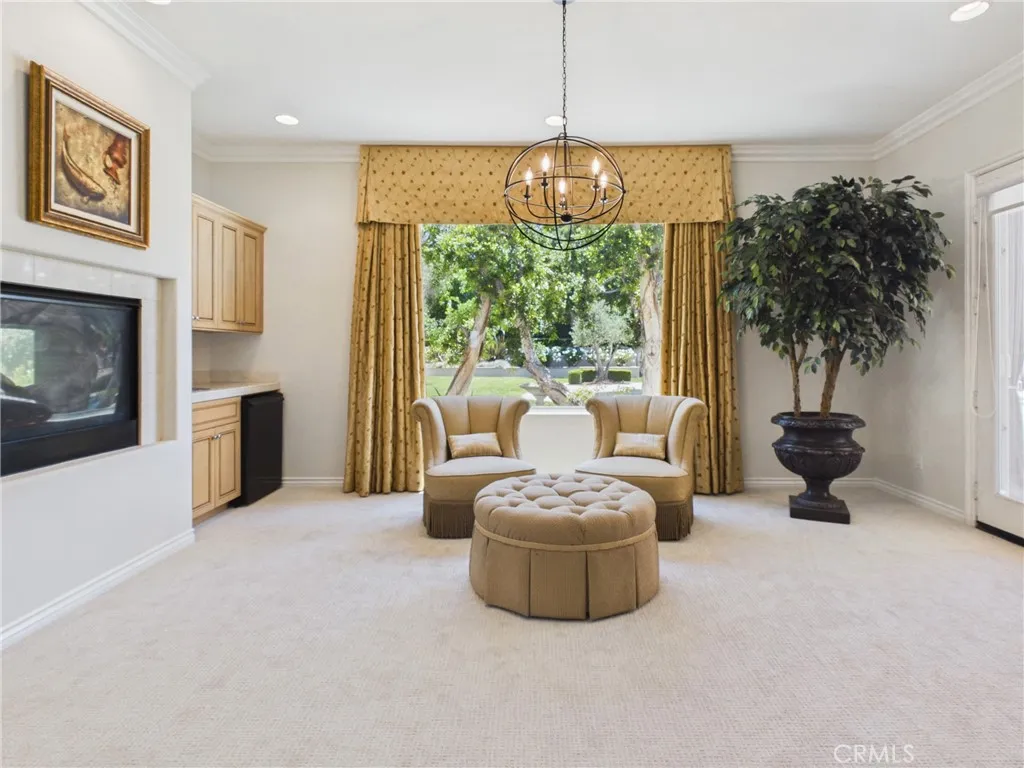 Dual sided fireplace at sitting area with wet bar.