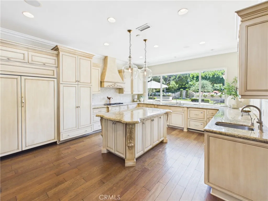 Built in Subzero fridge, warming drawer, double oven, extra sink and massive windows overlooking the backyard.