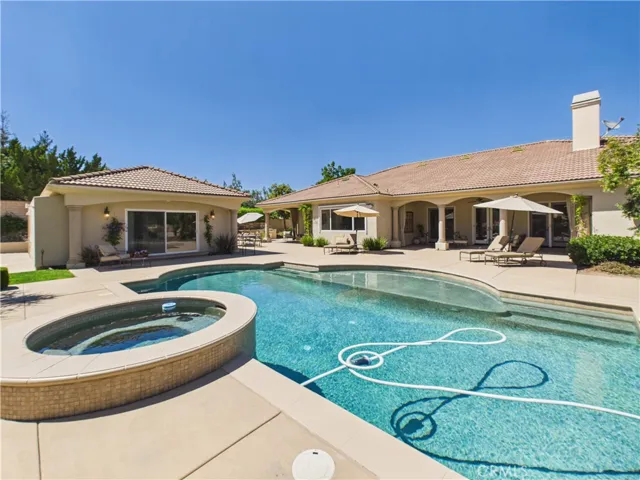 View of pool, ADU and back of home