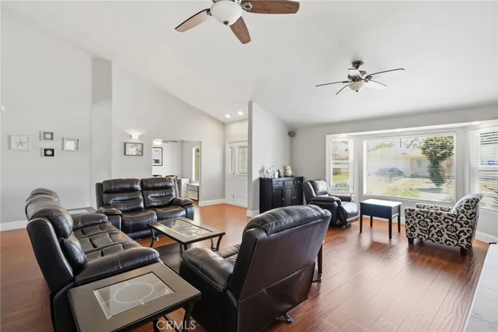 Step into the expansive living spaces highlighted by hardwood flooring, smooth vaulted ceilings, recessed lighting, updated windows, and designer finishes throughout.