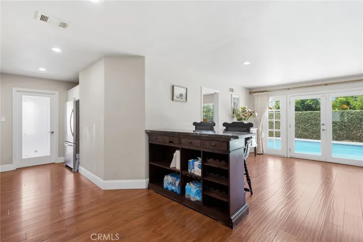 Adjacent dining and living spaces flow seamlessly to the backyard, creating the perfect indoor-outdoor lifestyle.