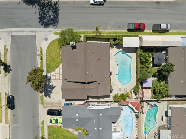 Situated on an oversized 6,700-square-foot interior corner lot, the private backyard is an entertainer's dream featuring a sparkling pool, expansive patio areas, mature landscaping, and multiple spaces for outdoor dining and relaxation.