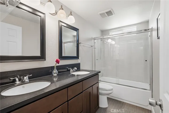 3rd full bath with dual wash basins and upgraded cabinets
