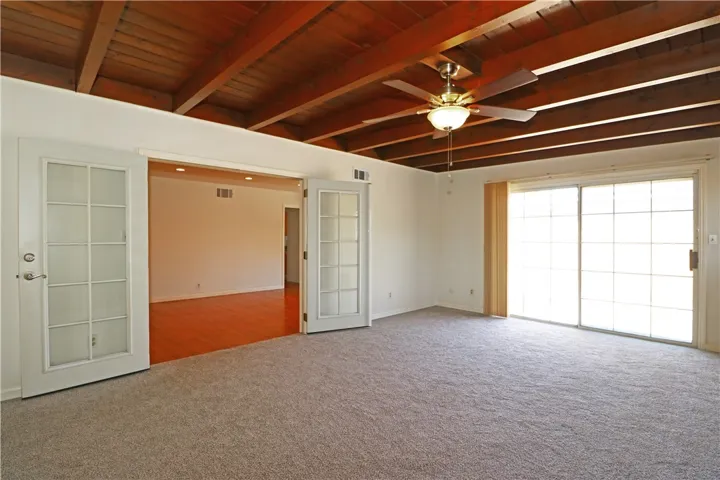 Spacious living room with access to 2 car garage and a slider leading to the backyard.