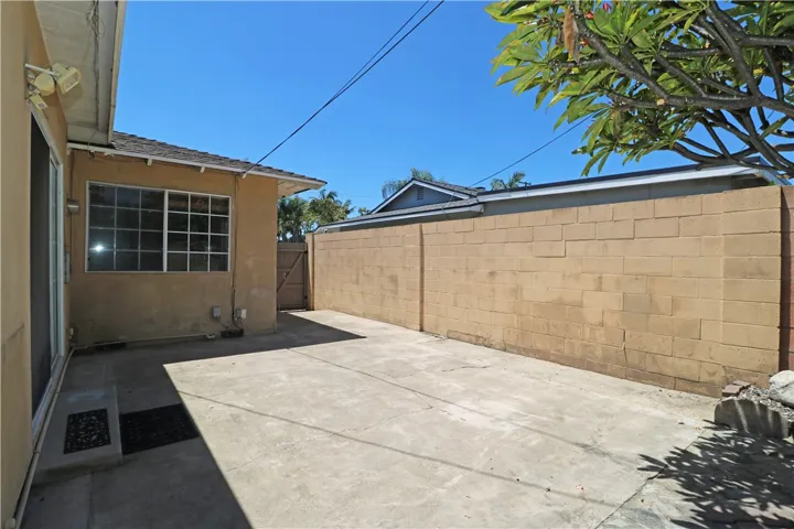 Spacious side yard and concrete patio.