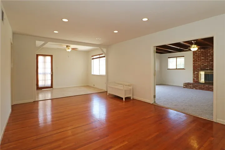 Family room with wood flooring and a dining area near the kitchen.