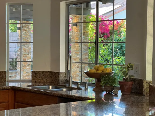 Spacious kitchen with a scenic view of the backyard, perfect for preparing meals.