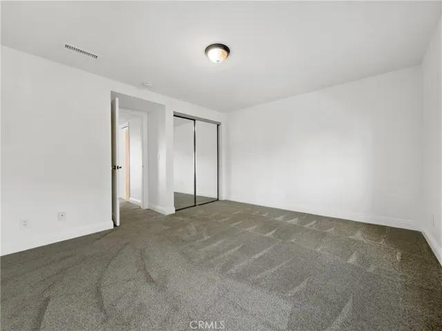 with a walk in closet as well as the double mirrored door closet