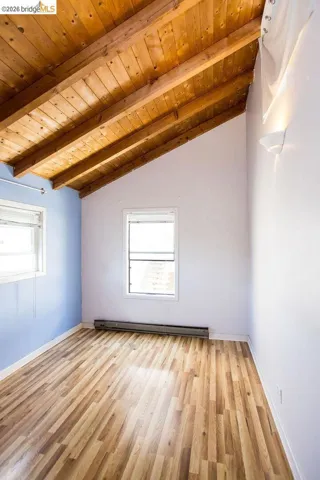 Room featuring an exposed wood plank vaulted ceiling
