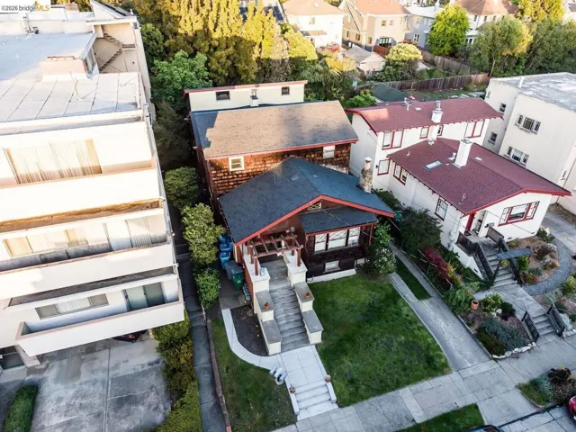 Craftsman-style residence featuring a dark-toned exterior with red trim