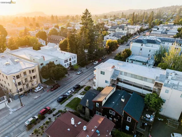 Street lined with multi-story buildings and residential structures