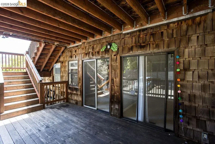 Expansive wood deck with exposed wood beam ceiling
