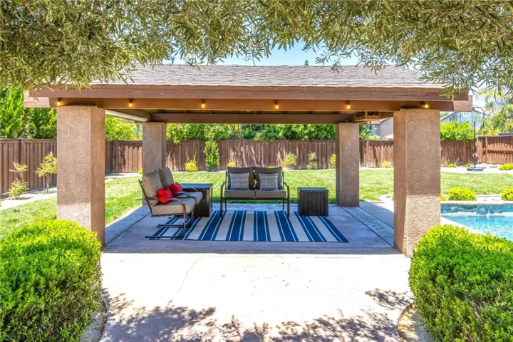 Covered outdoor pavilion overlooking the pool and backyard
