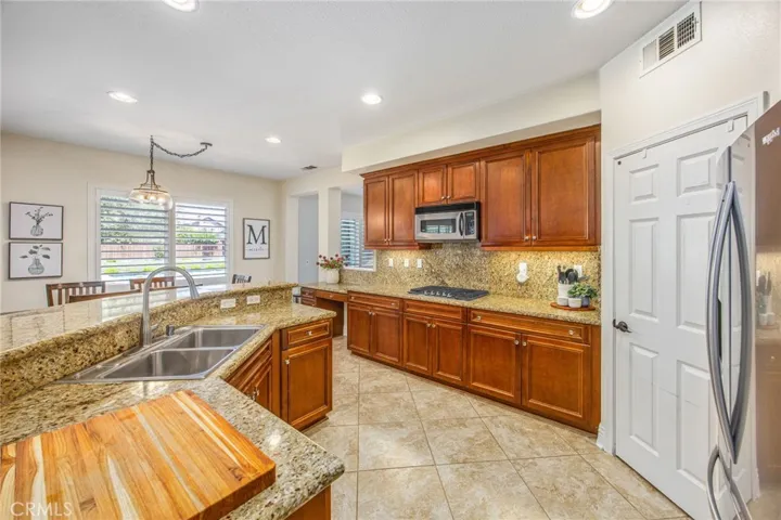 Well-appointed kitchen with granite countertops, plentiful cabinetry, and generous prep space