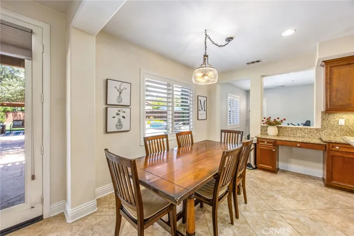 Breakfast nook with backyard views and convenient access to the covered patio