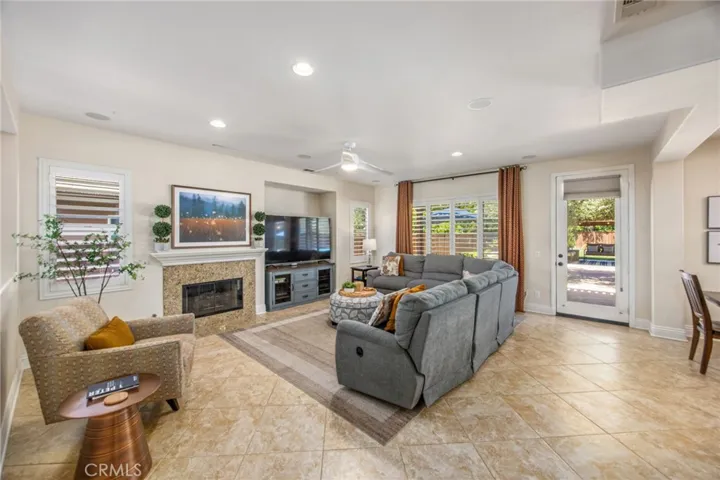 Spacious family room with a fireplace and seamless access to the backyard