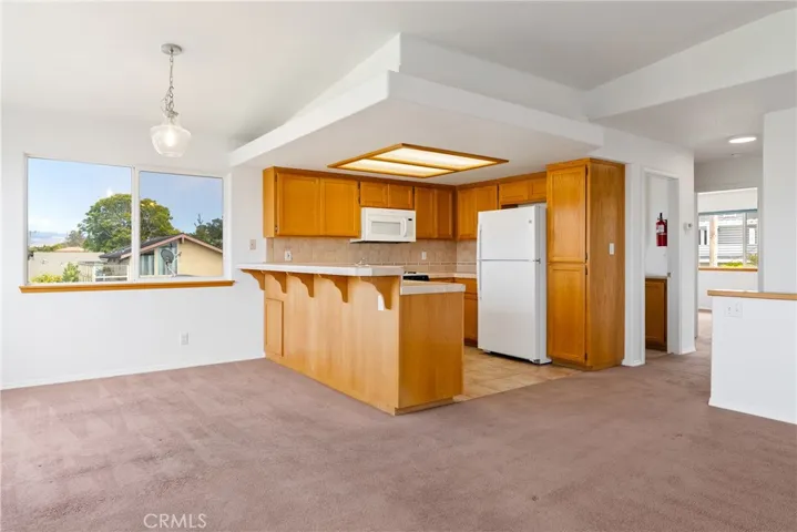The kitchen design allows for ample storage space and usable counter top space