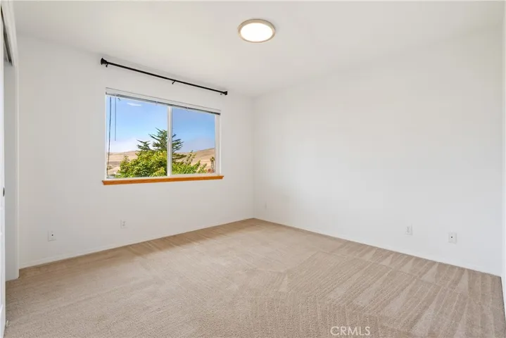 Downstairs bedroom with views of the backyard and hills