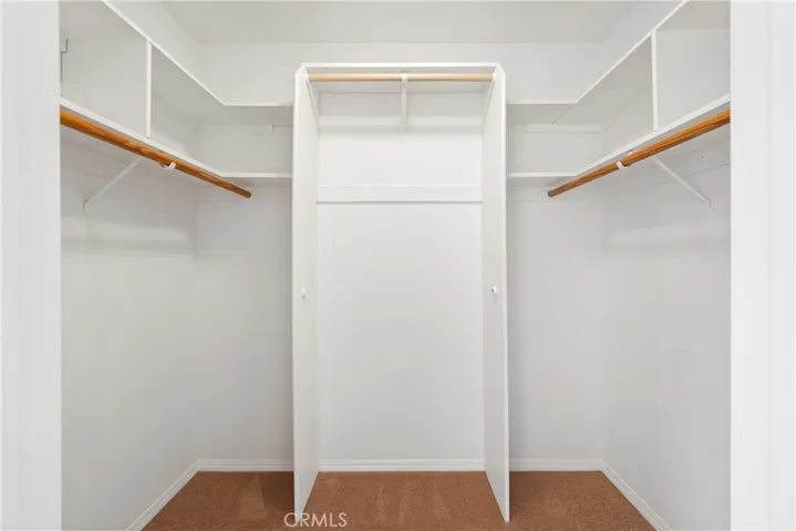 Walk in closet in primary bedroom