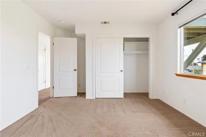 Spacious downstairs bedroom with clothes closet and hallway closet for extra storage