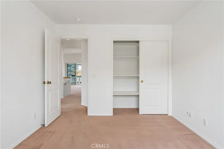 Second bedroom has closet with shelving, lots of natural light from south facing window