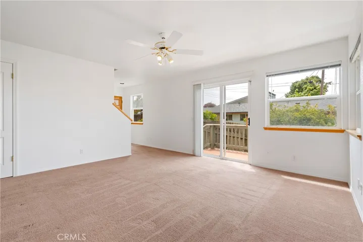 Downstairs living room has separate deck access to the backyard and to the front entry