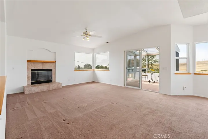Spacious living room with raised ceilings opens up to enclosed sunroom and deck,  panoramic views from the North Coast to the surrounding hills and peaks to the Northeast