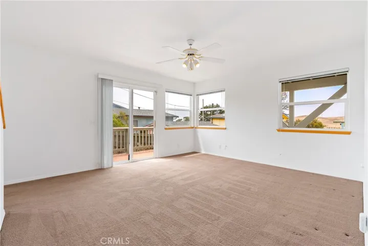 Downstairs is a spacious living room with its own deck and access.   It has the potential to be a separate living area. Refer to floor plan