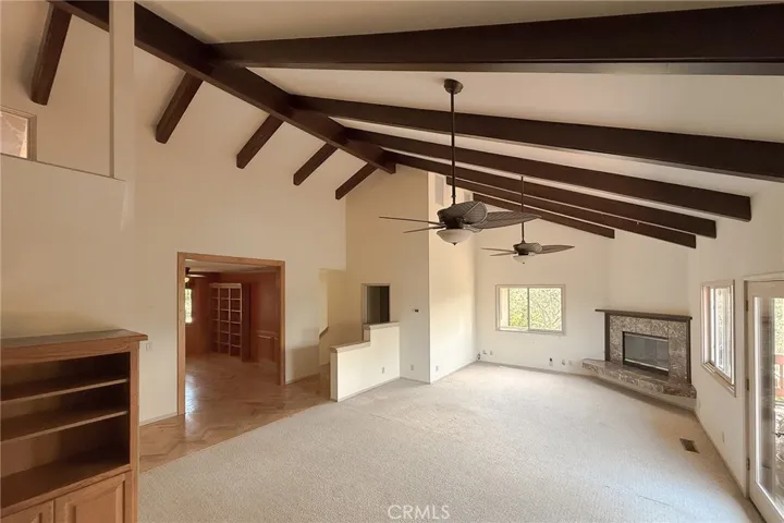 Designed for gathering, the living room opens to the formal dining room to the left
