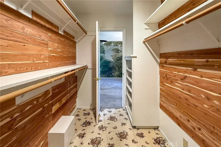 Spacious cedar-lined walk-in closet with custom built-ins