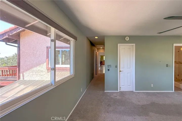 View from primary bedroom down the hall to living area