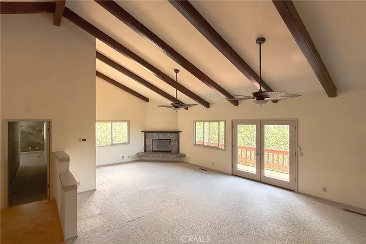 From the entry - Living room with vaulted ceilings and exposed wood beams.