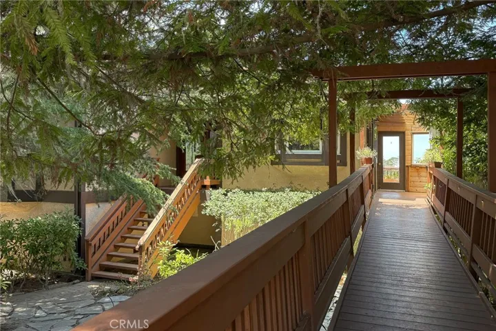 Accessibility ramp provides access from the front yard to the enclosed deck and kitchen entry