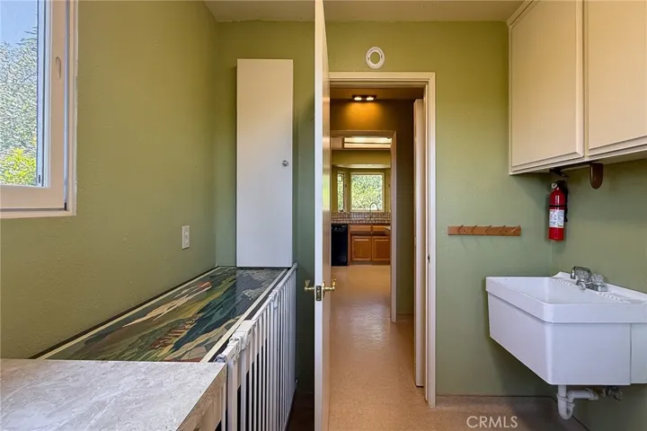 Laundry room with a built-in ironing board
